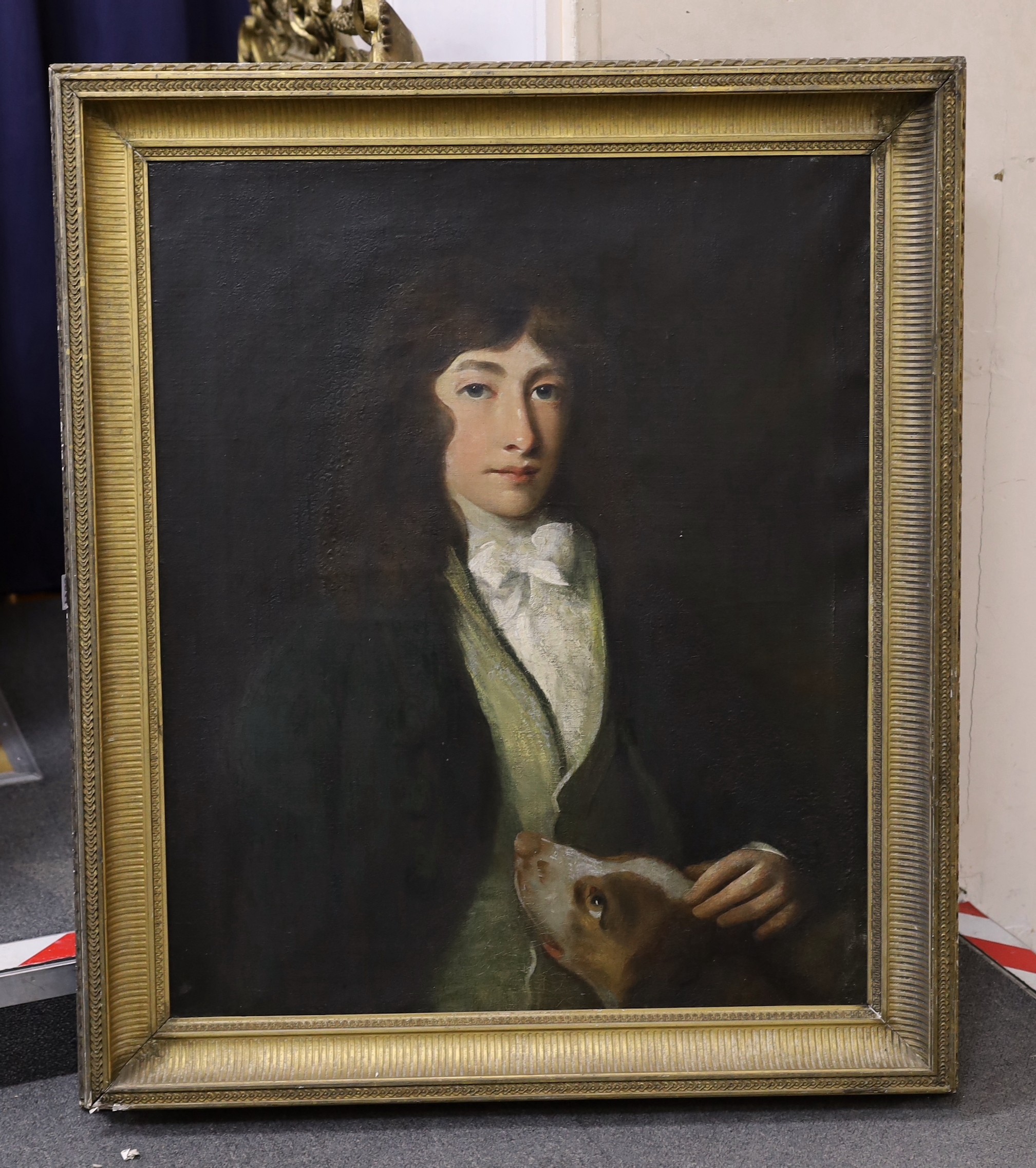Early 19th century English School, oil on canvas, Portrait of a young man, half length, with a hound, 75 x 63cm